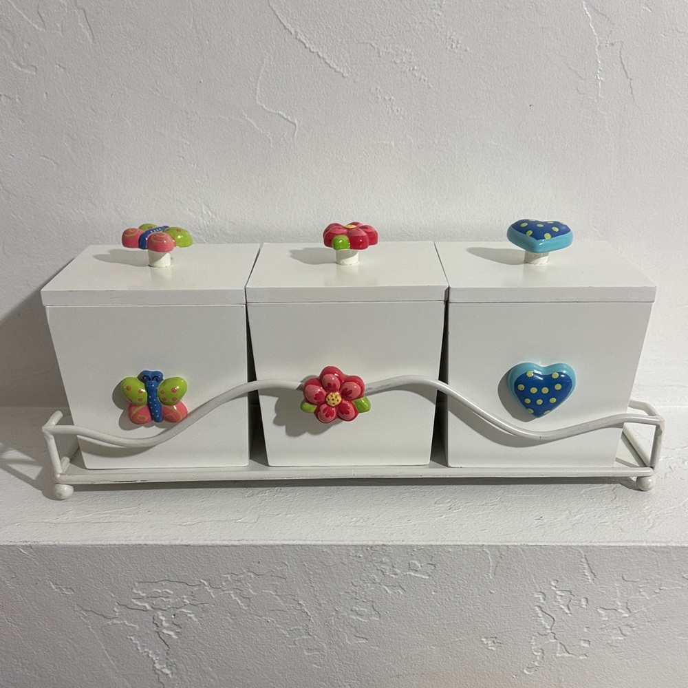 Decorative storage boxes with a white metal stand
